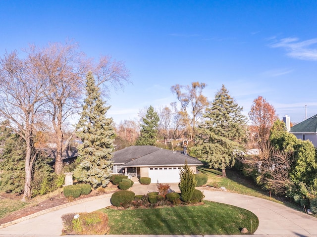 view of front of property with a garage and a front lawn