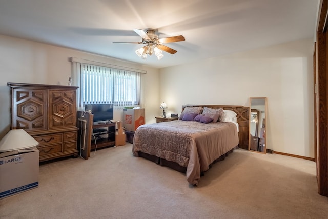 bedroom with ceiling fan and light colored carpet