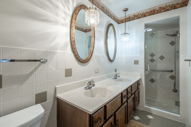 bathroom with vanity, tile patterned flooring, toilet, tile walls, and walk in shower