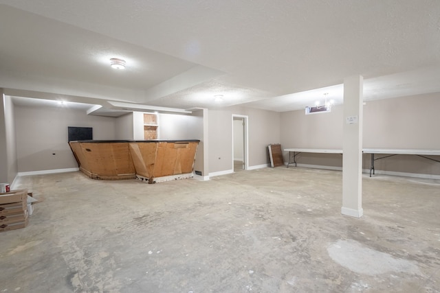 basement featuring a textured ceiling