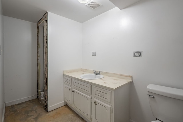 bathroom with vanity, concrete floors, and toilet