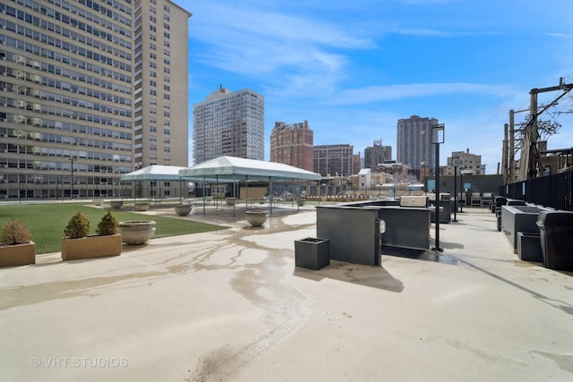view of patio / terrace featuring a gazebo and a view of city