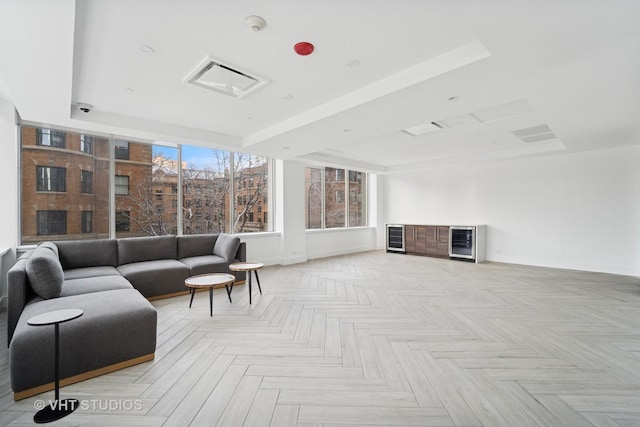 interior space featuring a tray ceiling and baseboards