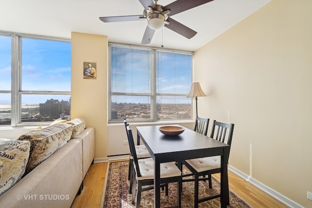 dining area featuring a wealth of natural light, wood finished floors, and ceiling fan