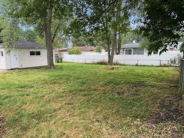 rear view of property with cooling unit and a yard