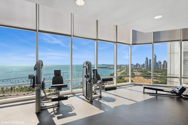 gym with a wall of windows, a view of city, and a water view