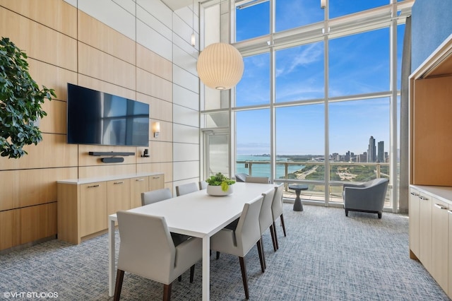 dining space featuring light colored carpet and floor to ceiling windows