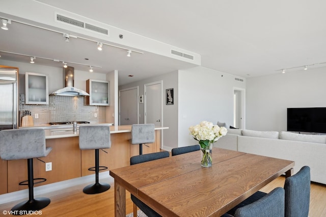 dining room featuring light wood-type flooring and visible vents