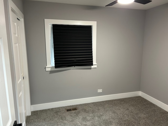 carpeted spare room featuring ceiling fan