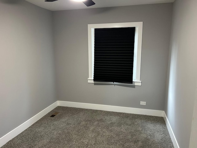 unfurnished room featuring ceiling fan and carpet floors