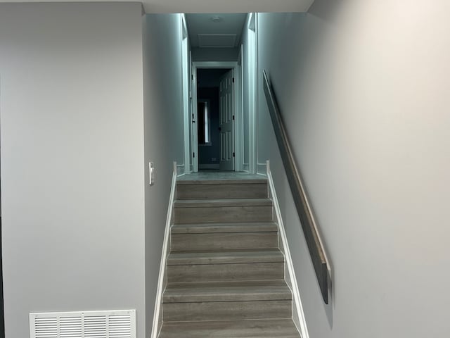 stairway with hardwood / wood-style floors