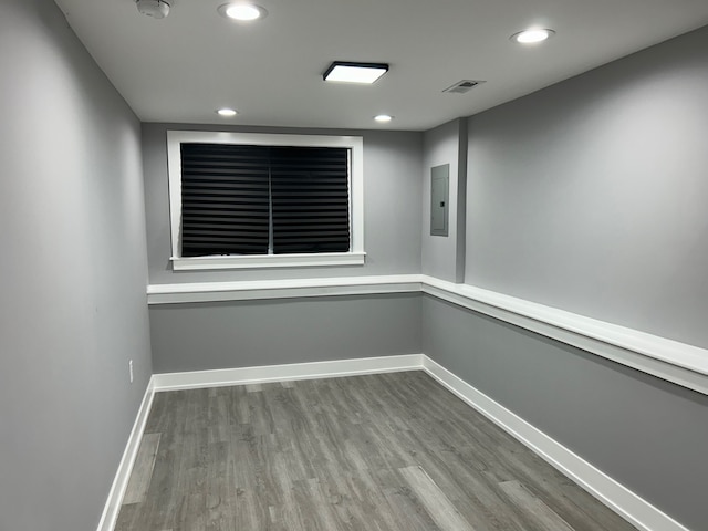 empty room featuring wood-type flooring and electric panel