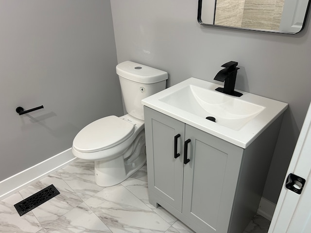 bathroom featuring tile patterned floors, vanity, and toilet