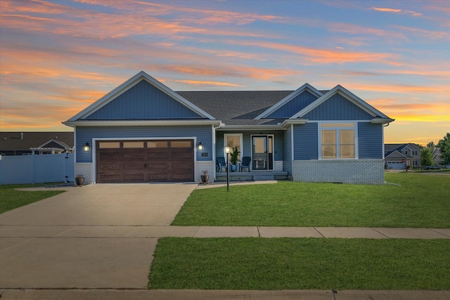 craftsman inspired home with a yard and a garage