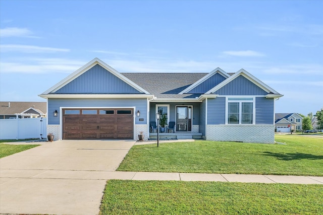 craftsman inspired home with a front yard and a garage