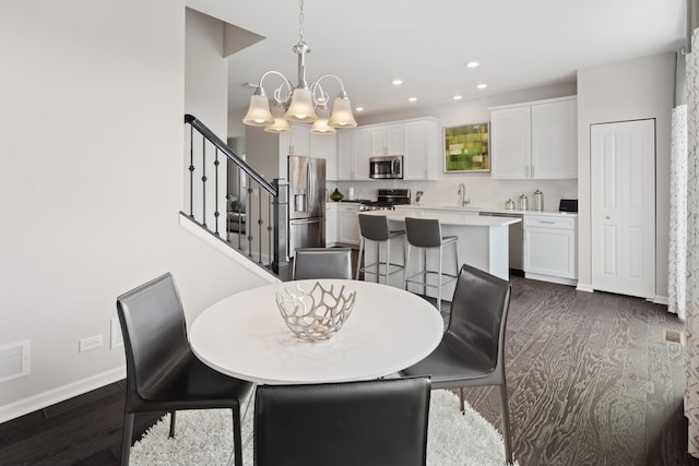 dining room with a chandelier and dark hardwood / wood-style floors