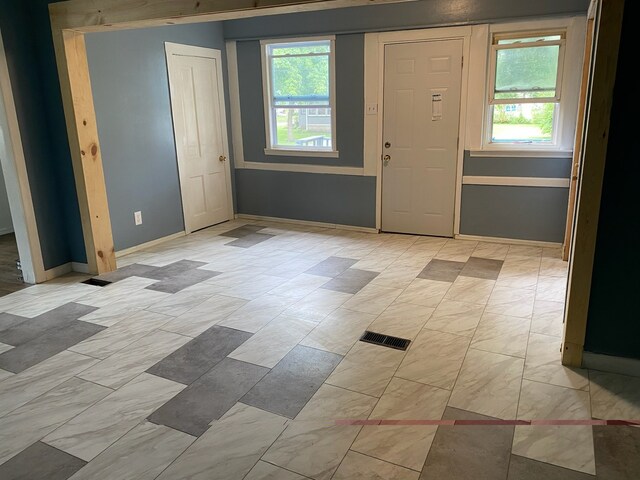 entryway featuring baseboards