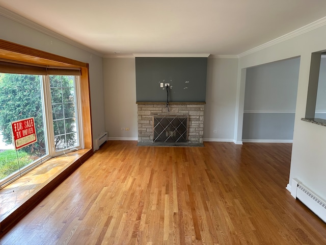 unfurnished living room with light hardwood / wood-style flooring, a baseboard heating unit, and a stone fireplace