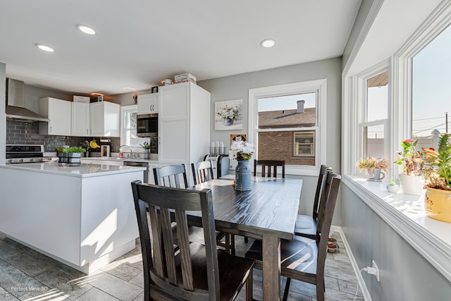 dining space featuring sink and light hardwood / wood-style flooring