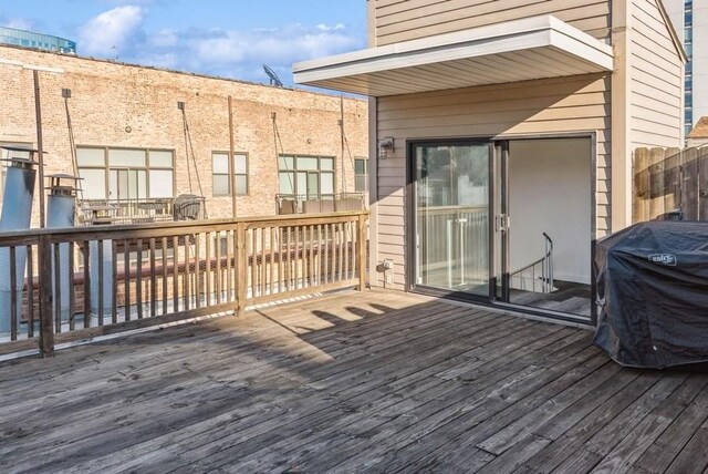 wooden terrace with a grill