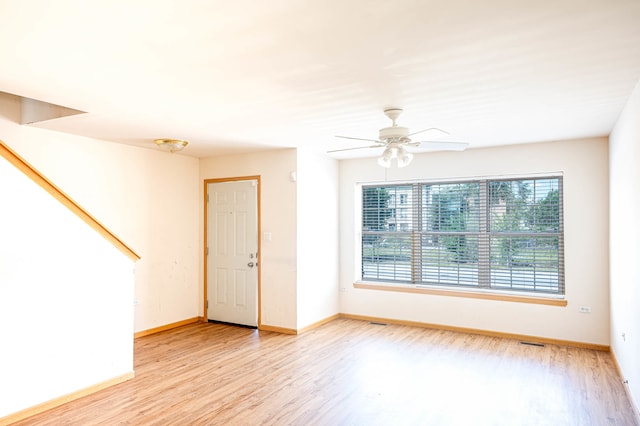 spare room featuring ceiling fan and light hardwood / wood-style flooring