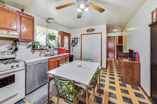 kitchen with ceiling fan, sink, backsplash, dishwasher, and white stove