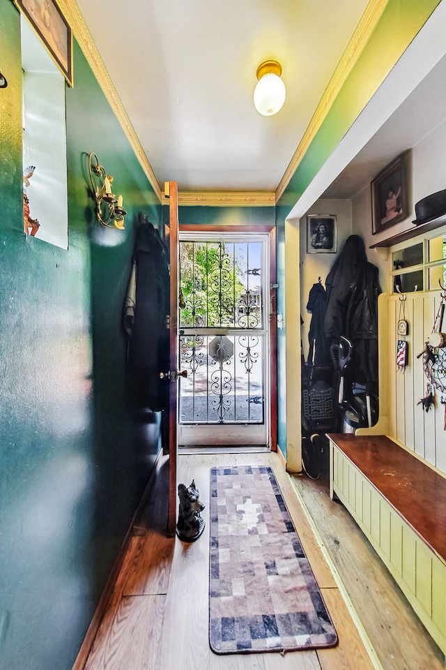 mudroom with hardwood / wood-style flooring and crown molding