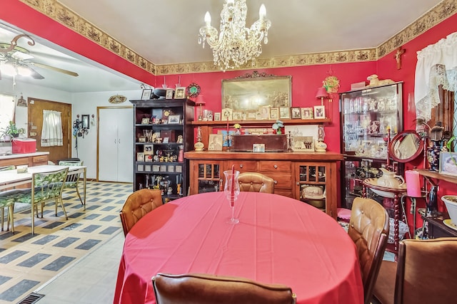 dining space with ceiling fan with notable chandelier