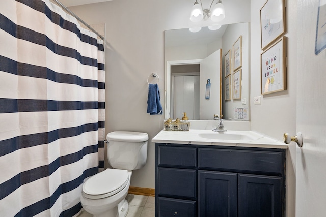 bathroom featuring a chandelier, toilet, vanity, baseboards, and tile patterned floors