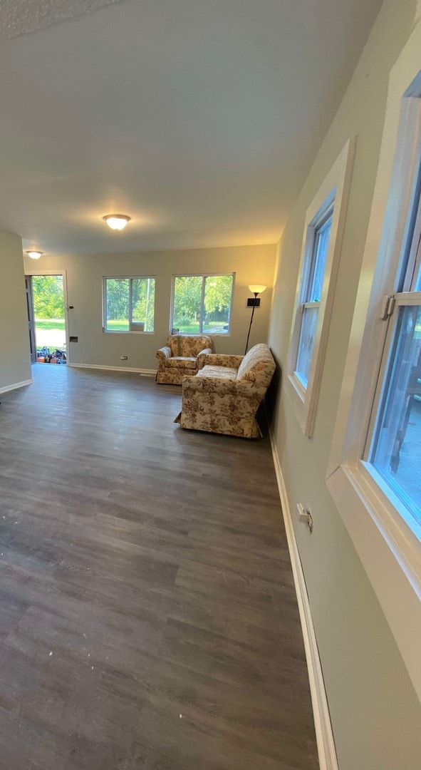 unfurnished living room with dark hardwood / wood-style floors