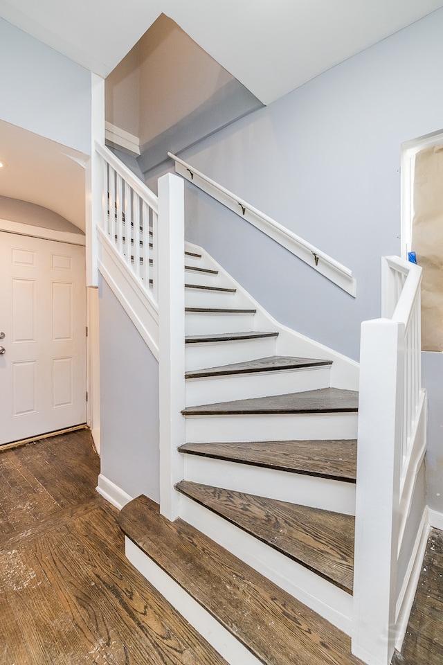 stairway with hardwood / wood-style floors