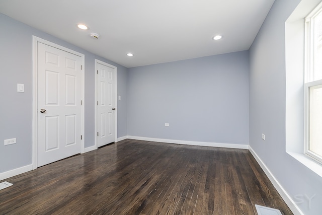 unfurnished bedroom featuring hardwood / wood-style flooring