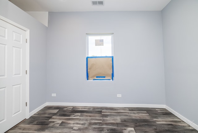 spare room with dark hardwood / wood-style floors