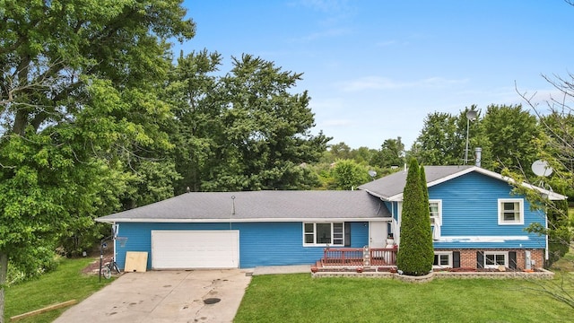 split level home with a front lawn and a garage