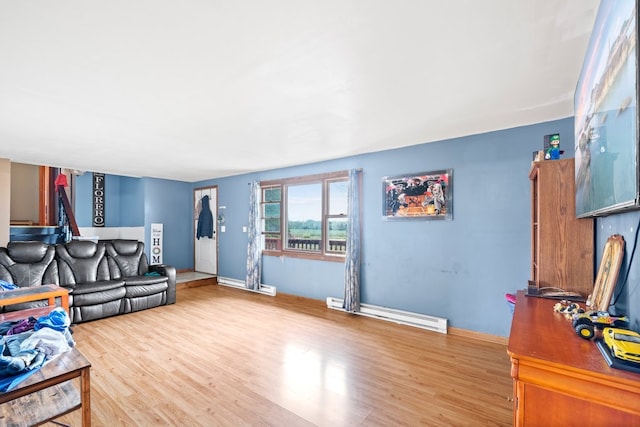 living room with light hardwood / wood-style floors and a baseboard heating unit