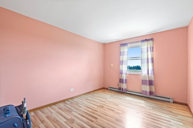 spare room with light hardwood / wood-style flooring and baseboard heating