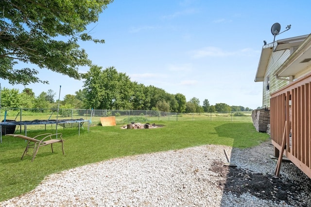 view of property's community featuring a trampoline and a lawn