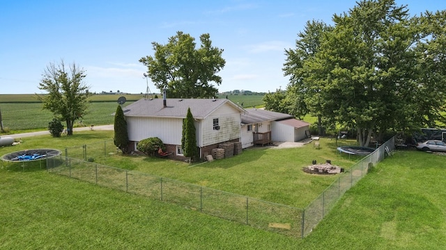 exterior space featuring a rural view and a yard