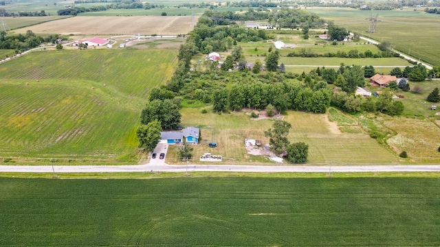 birds eye view of property with a rural view