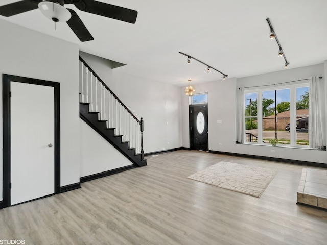 foyer with rail lighting, ceiling fan, and light hardwood / wood-style floors