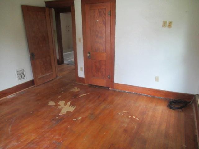 empty room with dark hardwood / wood-style floors