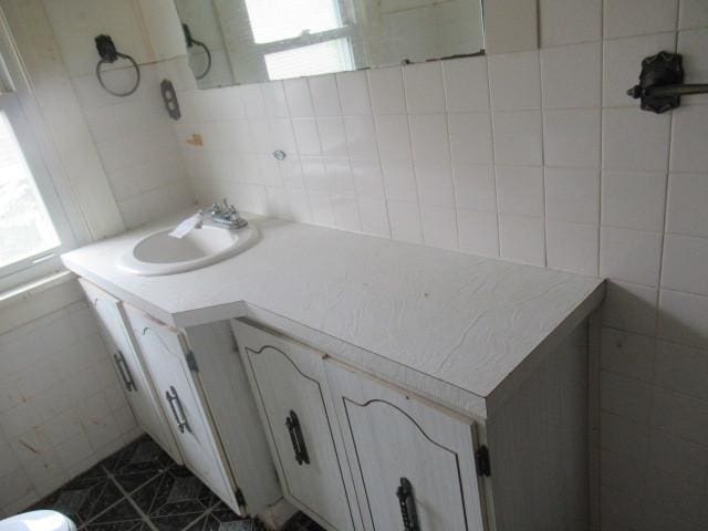 bathroom featuring tile walls, plenty of natural light, and vanity