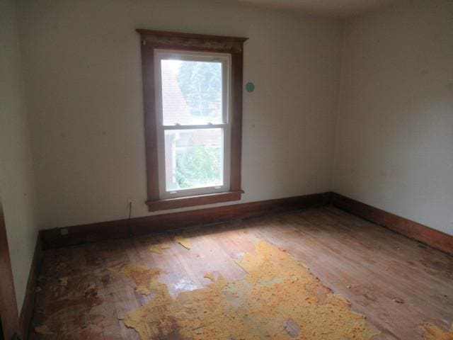 unfurnished room featuring hardwood / wood-style floors