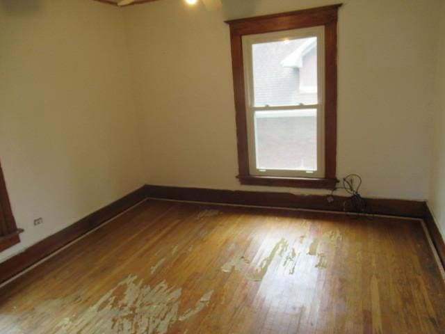 empty room featuring hardwood / wood-style flooring and ceiling fan