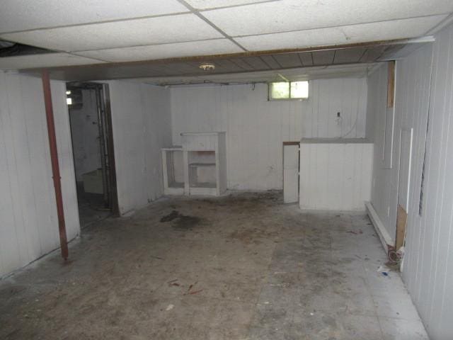 basement with a paneled ceiling