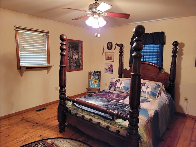 bedroom with wood-type flooring and ceiling fan