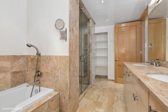 bathroom featuring vanity and separate shower and tub