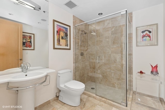 bathroom featuring a shower with shower door, toilet, and tile patterned floors