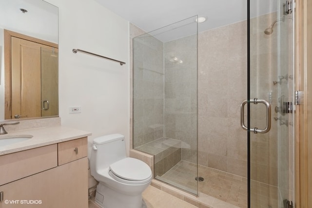 bathroom with tile patterned floors, toilet, walk in shower, and vanity