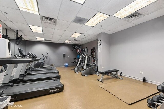 workout area featuring a paneled ceiling